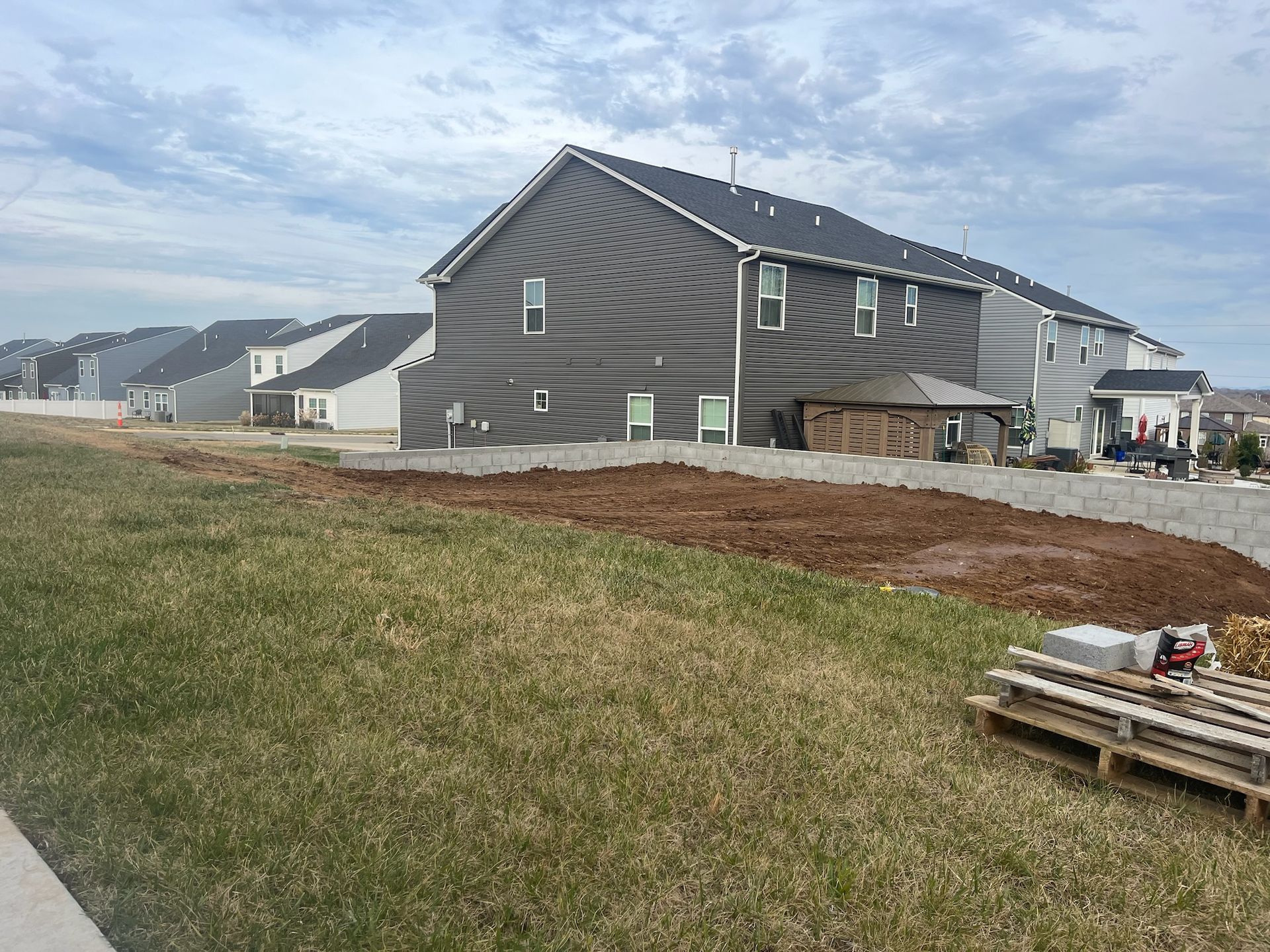A row of houses are being built in a residential area.