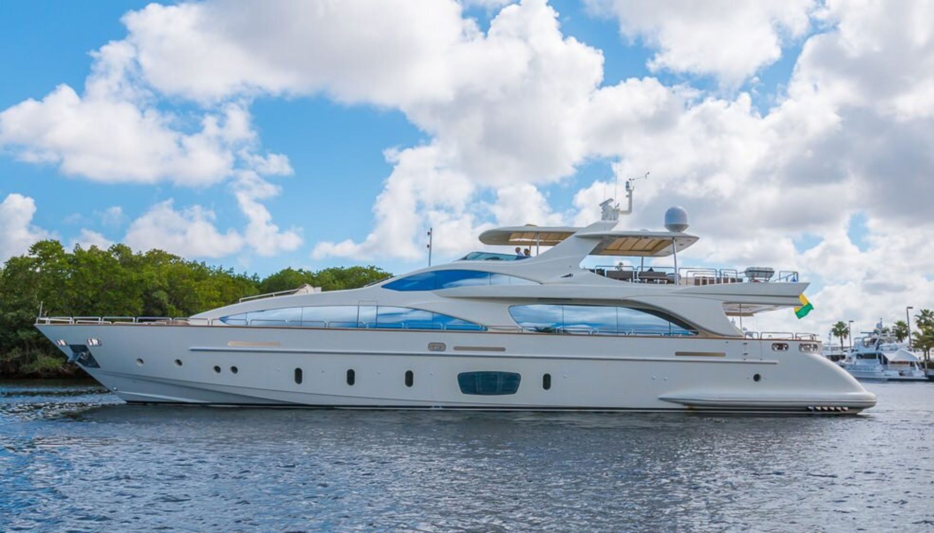 A large white yacht is floating on top of a body of water.