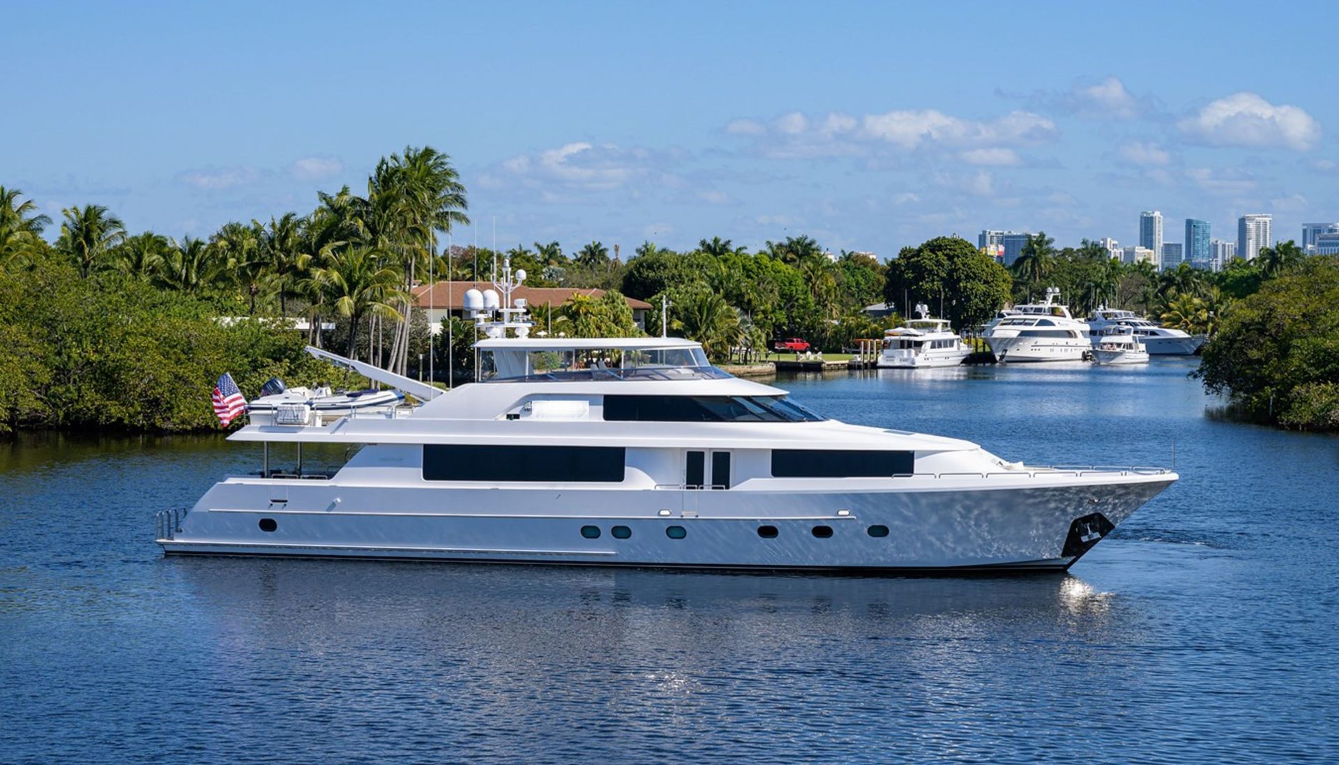 A large white yacht is floating on top of a body of water.