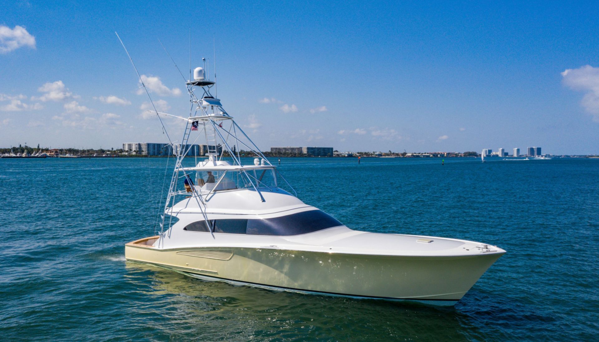 A large white yacht is floating on top of a large body of water.