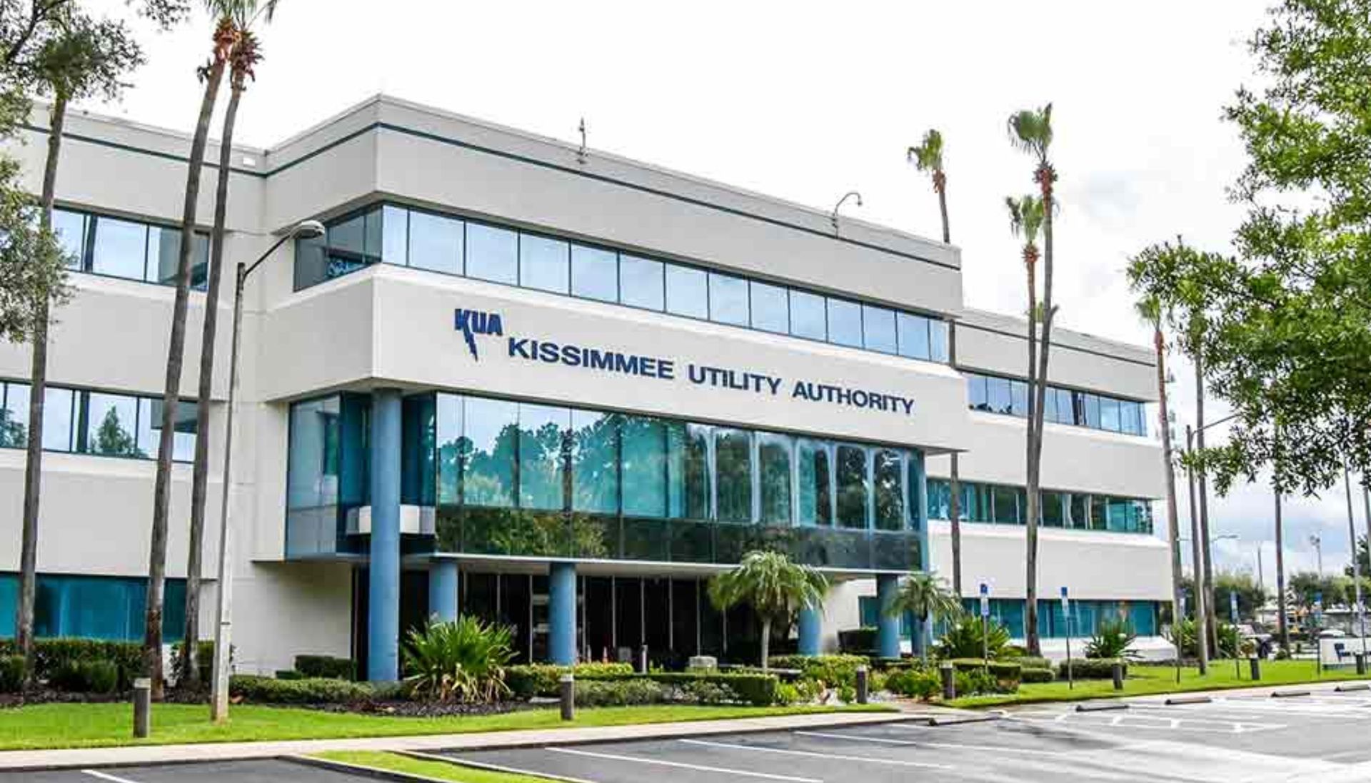 A large white building with a blue sign that says horseshoe utility authority