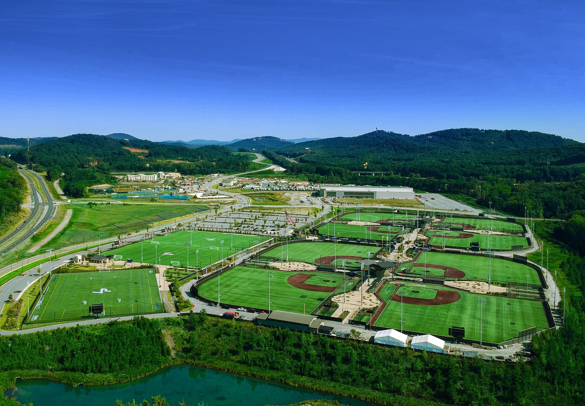 An aerial view of a baseball field with mountains in the background.