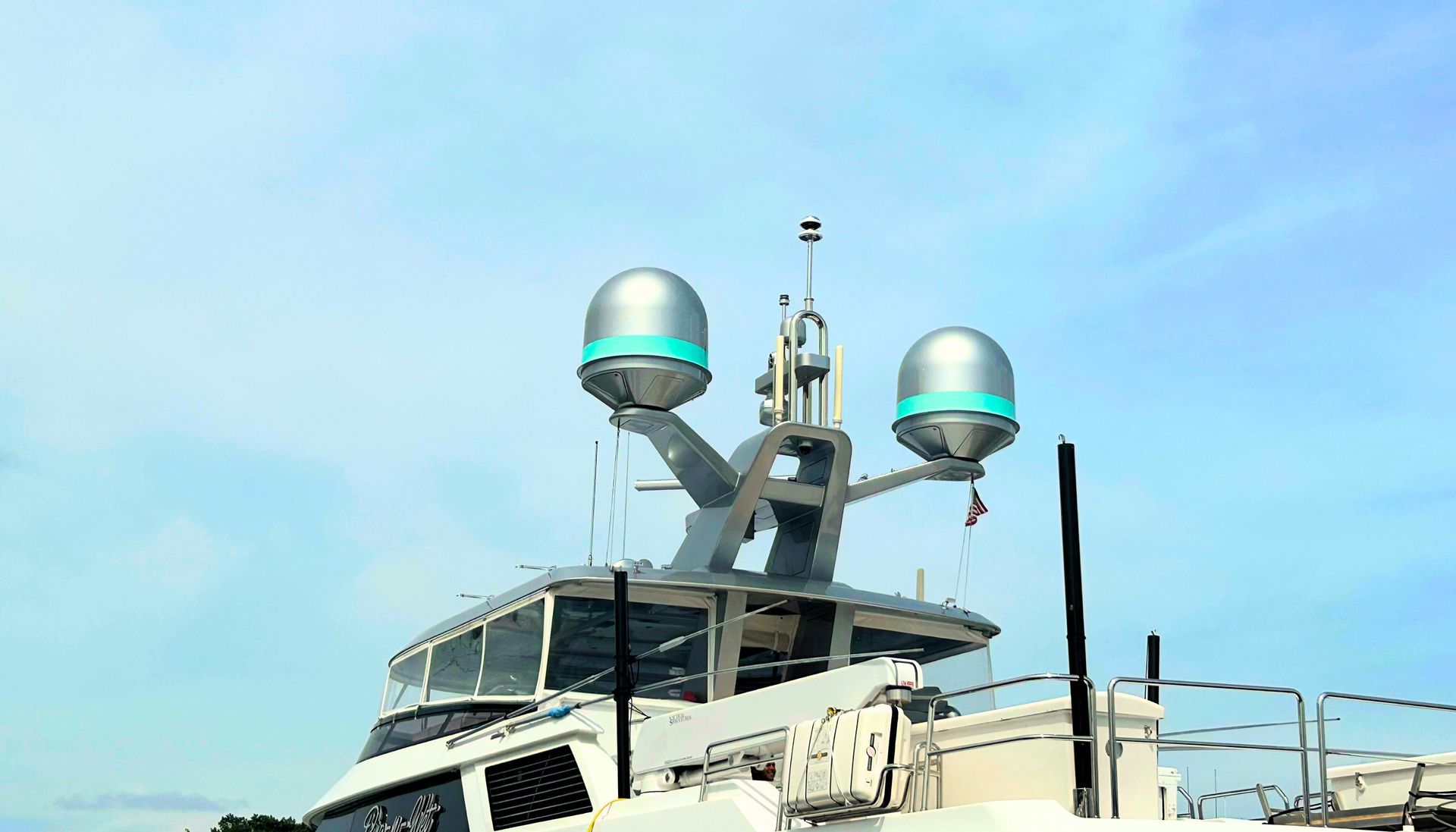 A large yacht with a lot of antennas on the top of it.