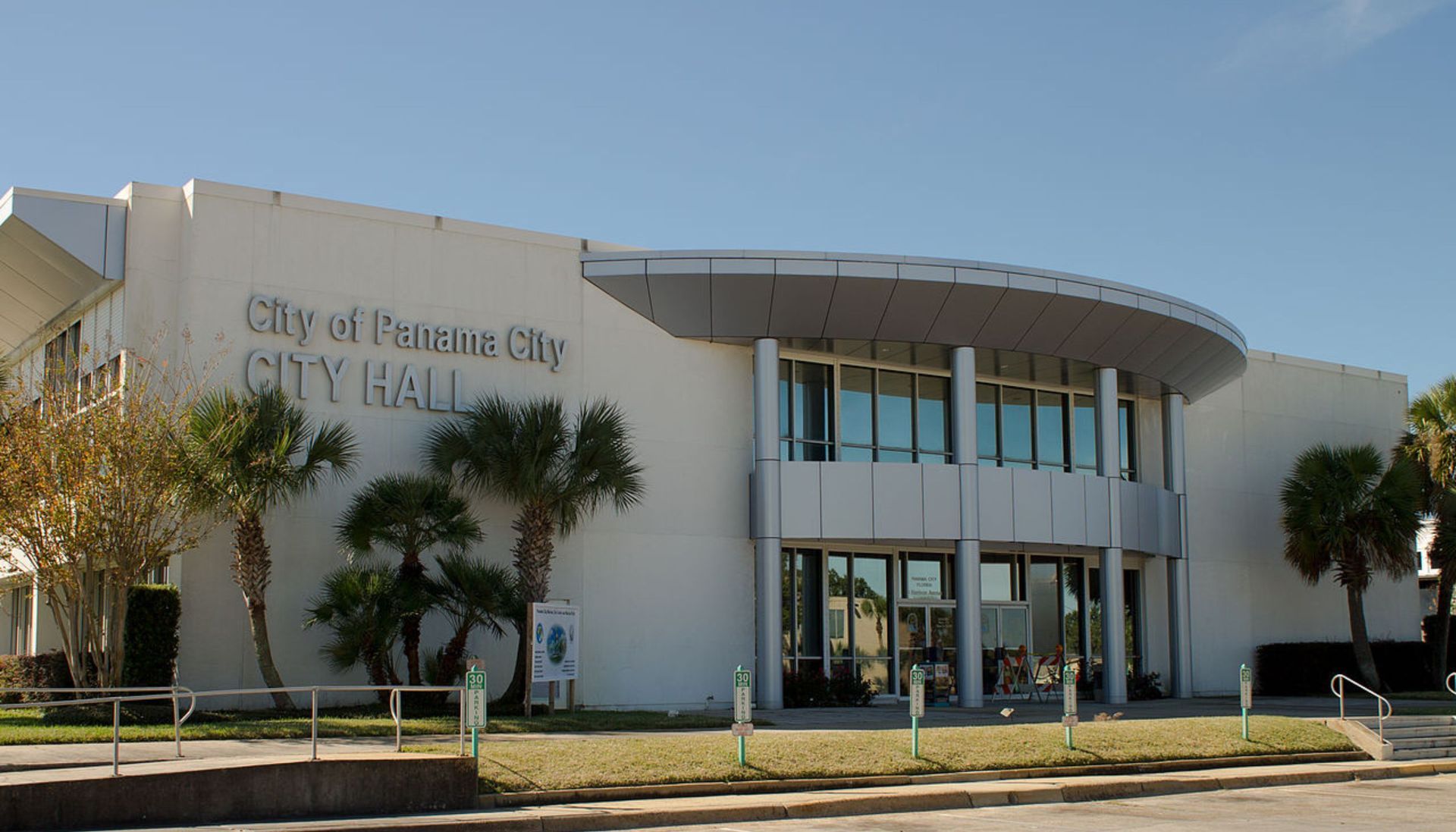 A large white building with the word city hall on it