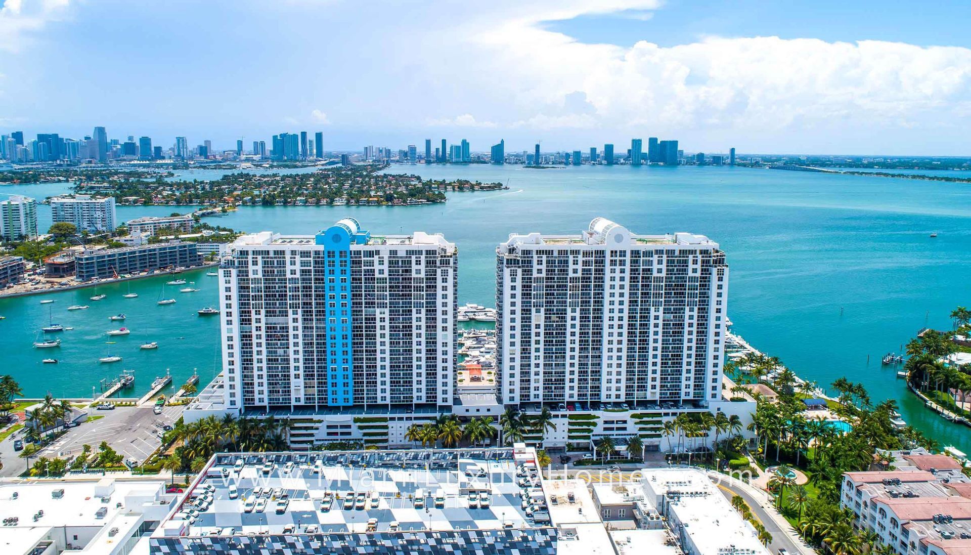 An aerial view of a large building next to a body of water.