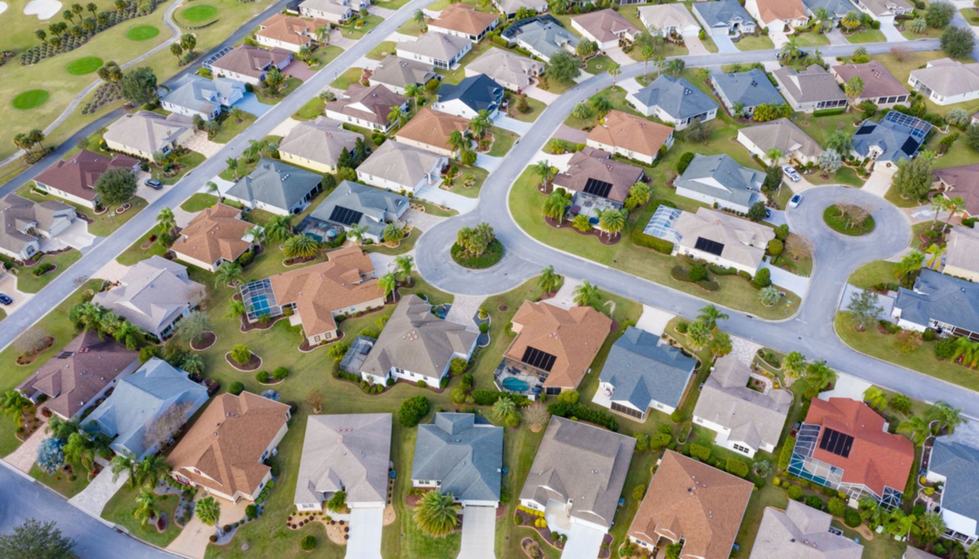 An aerial view of a residential neighborhood with lots of houses and trees.