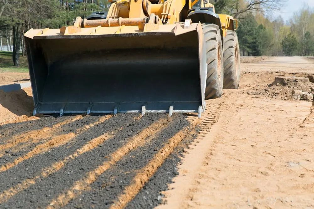 A Bulldozer is Moving Dirt on a Road —  A & B Mullins Excavations Pty Ltd in Bundaberg, QLD