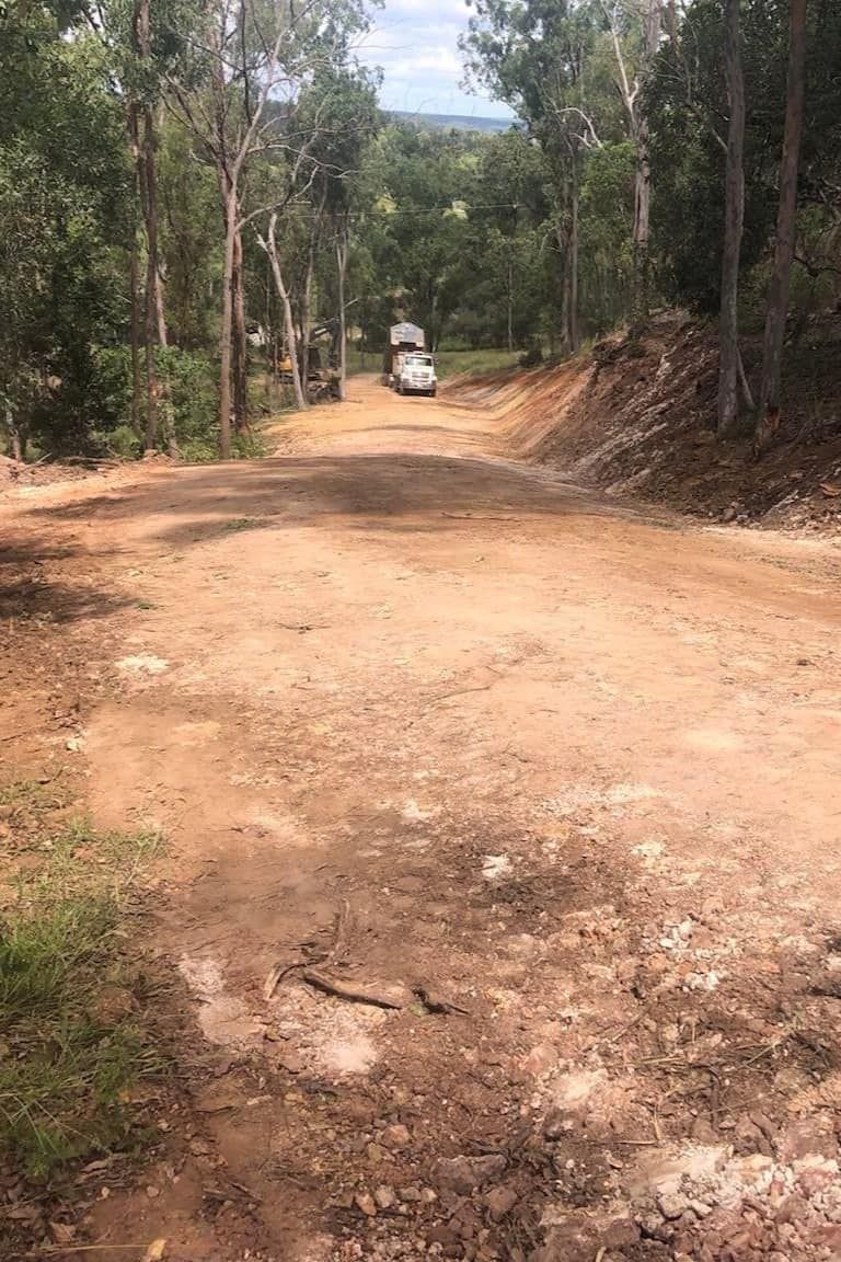 A Truck is Driving Down a Dirt Road in the Woods —  A & B Mullins Excavations Pty Ltd in Bungadoo, QLD