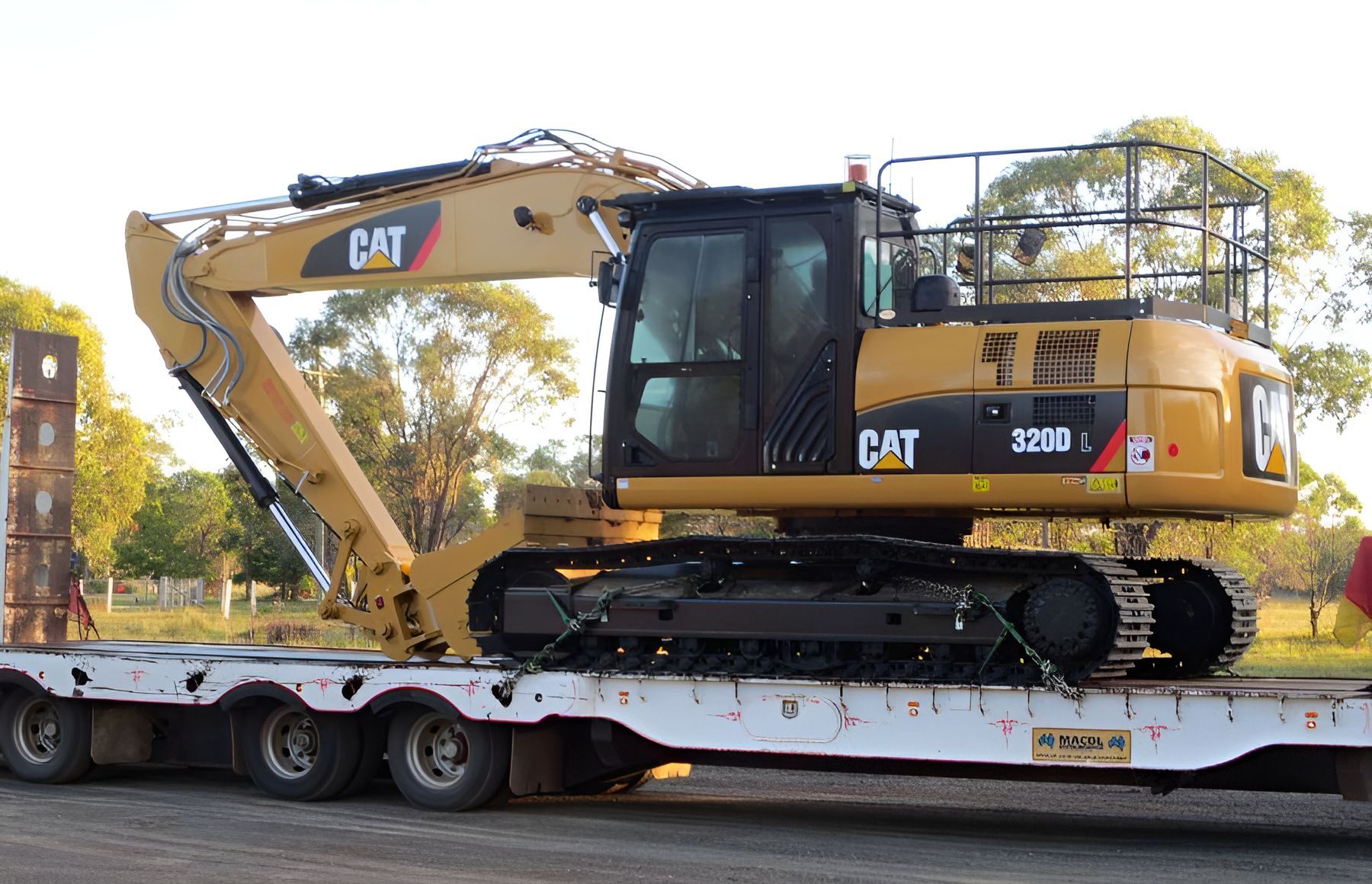 A Cat Excavator is Sitting on Top of a Trailer —  A & B Mullins Excavations Pty Ltd in Bargara, QLD