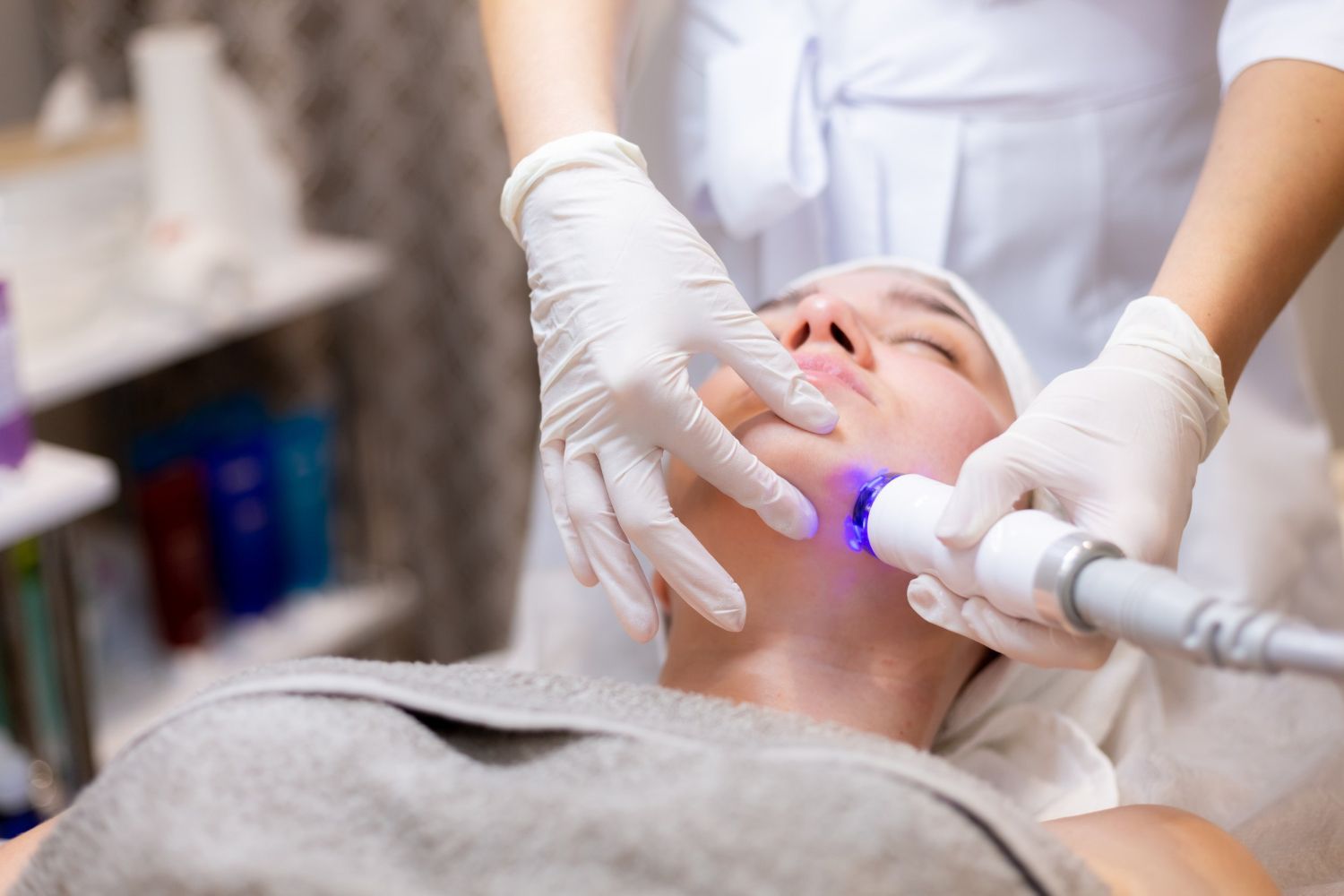 A woman is getting a facial treatment in a beauty salon.