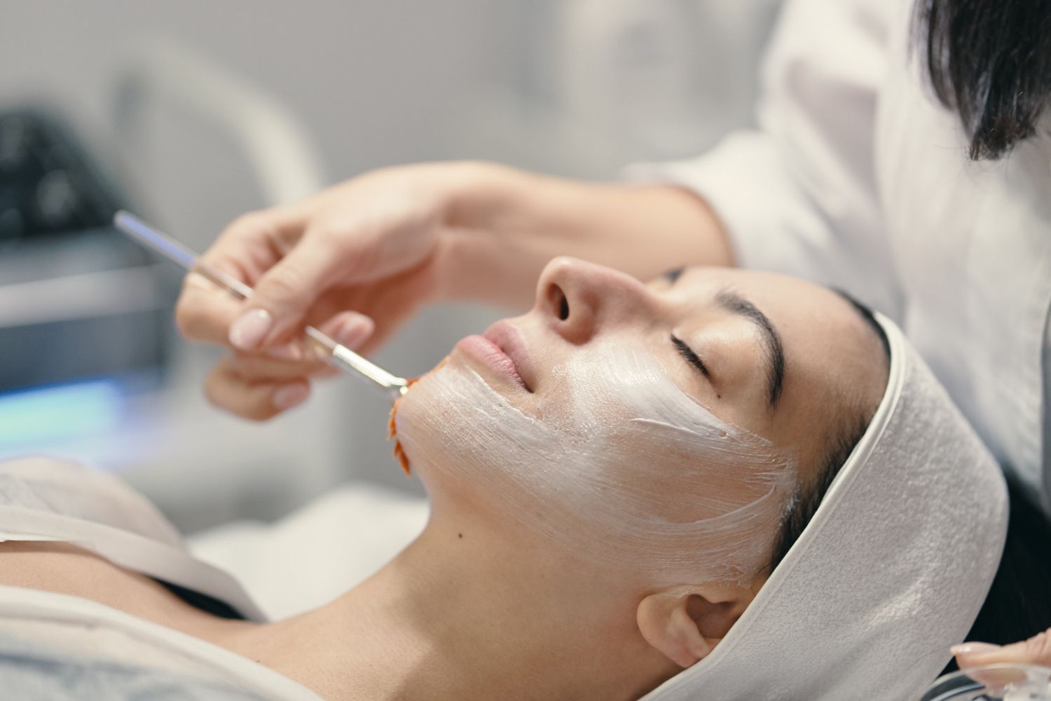 A woman is getting a facial treatment at a spa.