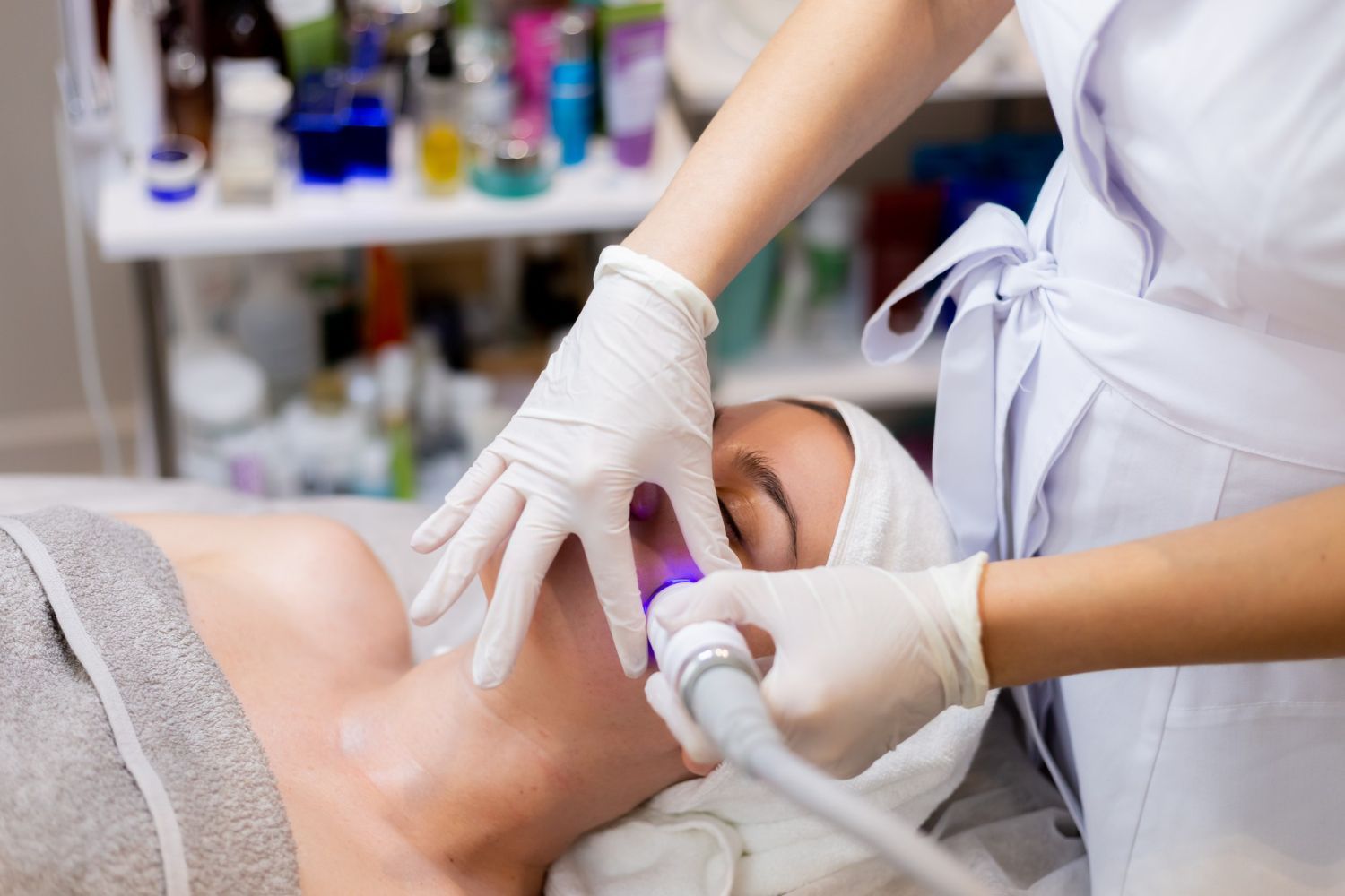 A woman is getting a facial treatment in a beauty salon.