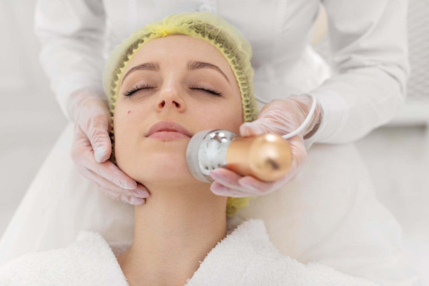 A woman is getting a facial treatment at a beauty salon.