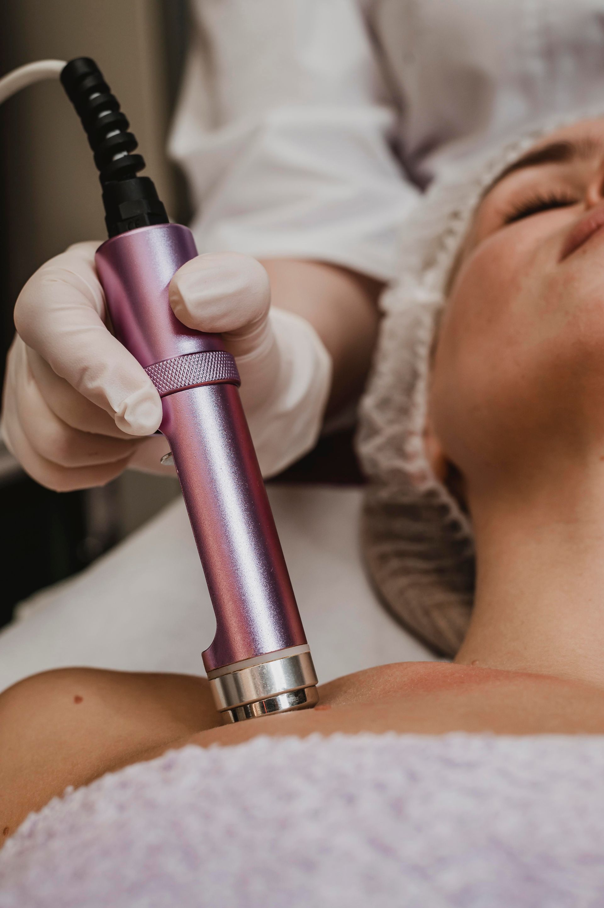 A woman is getting a facial treatment at a beauty salon.