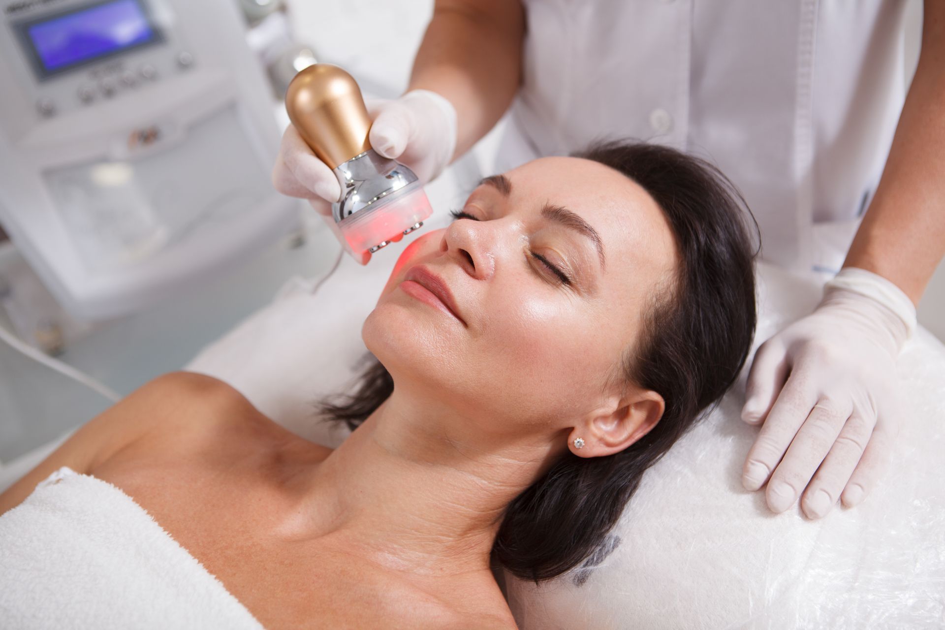 A woman is getting a facial treatment at a beauty salon.