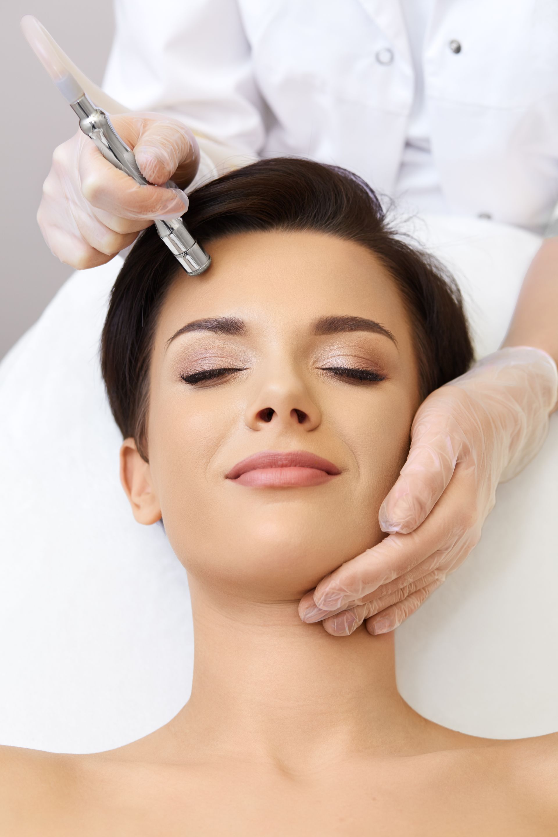 A woman is getting a facial treatment at a beauty salon.