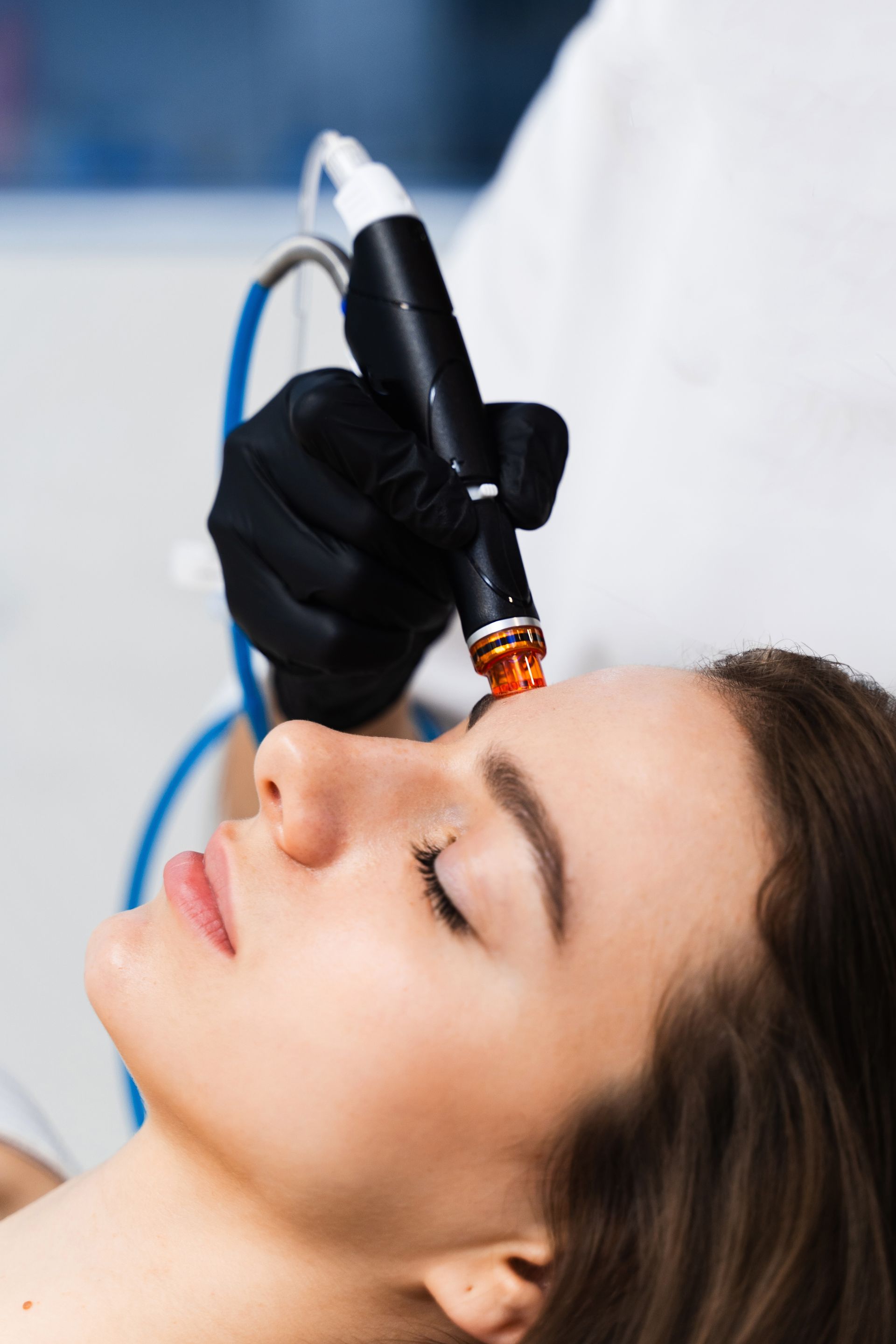 A woman is getting a facial treatment at a beauty salon.