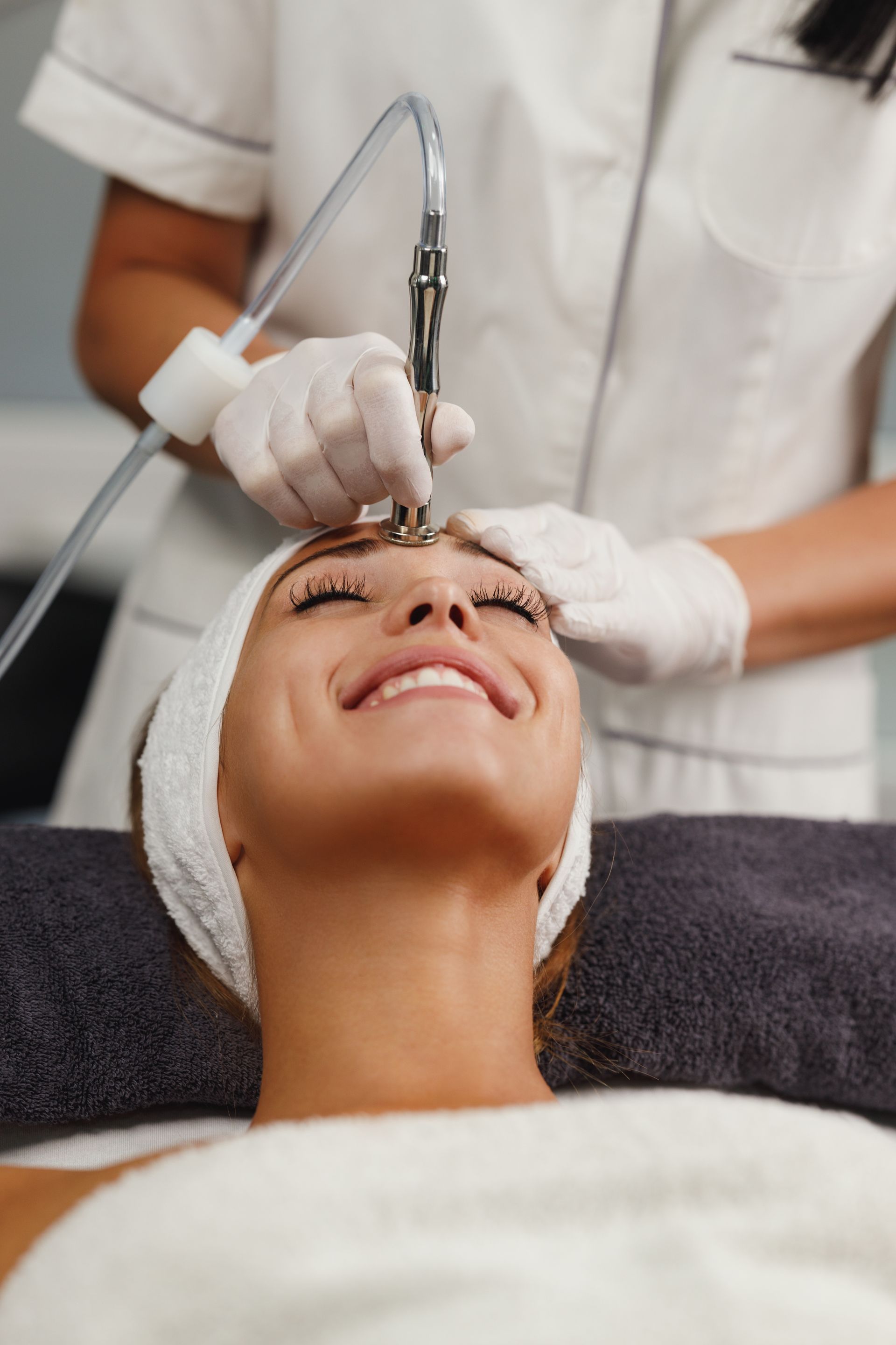 A woman is getting a facial treatment at a beauty salon.