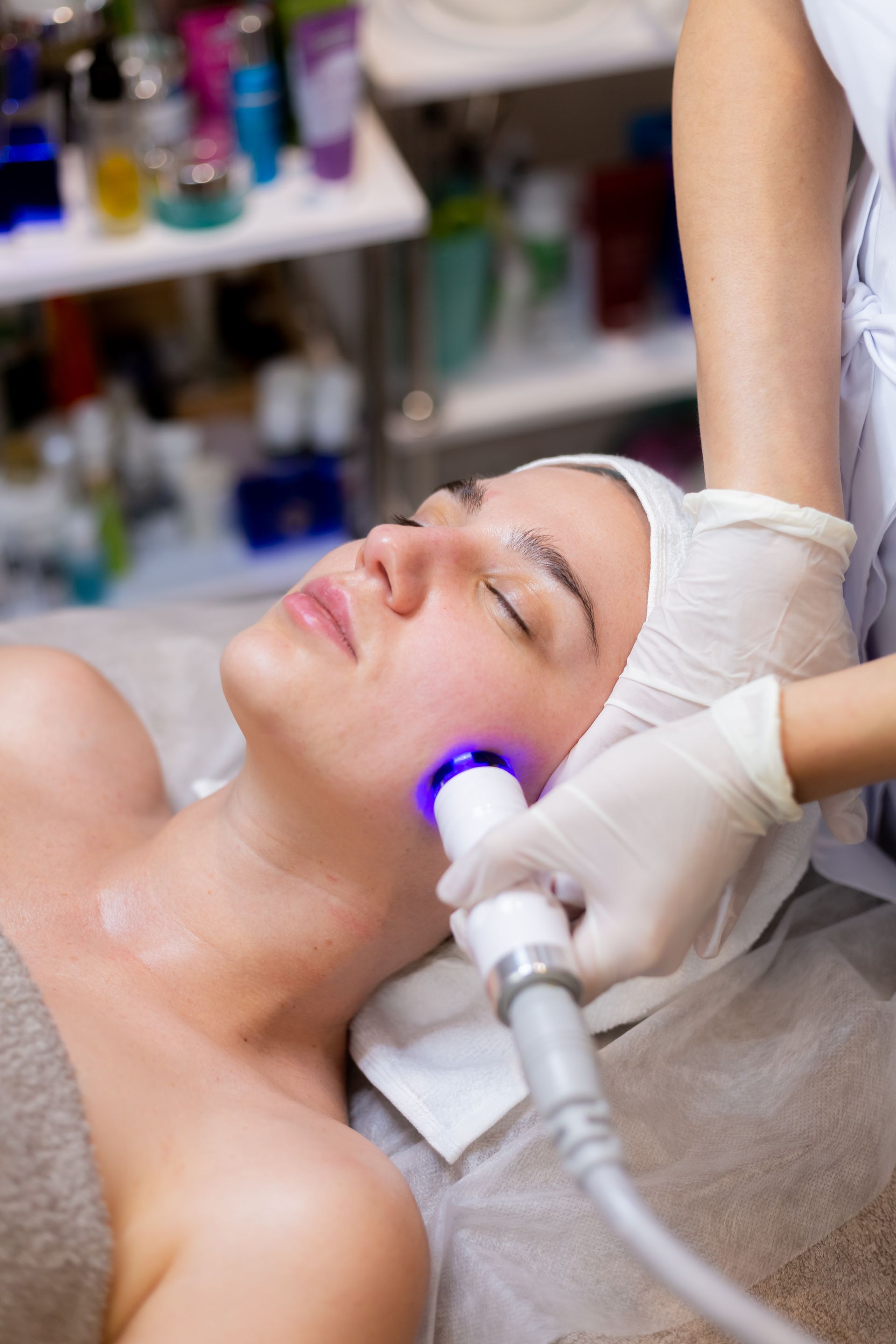 A woman is getting a facial treatment at a beauty salon.