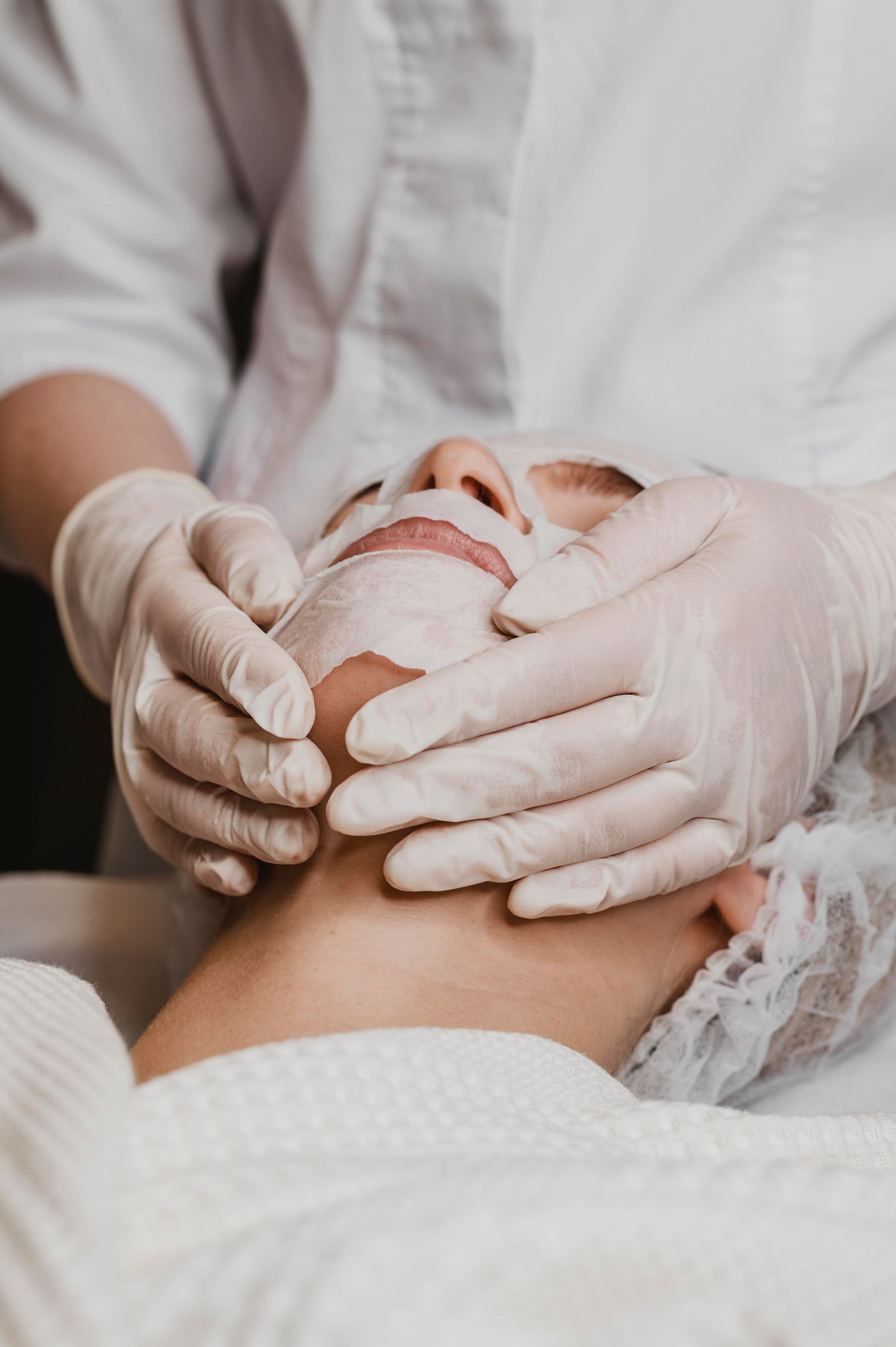 A woman is getting a facial treatment at a spa.