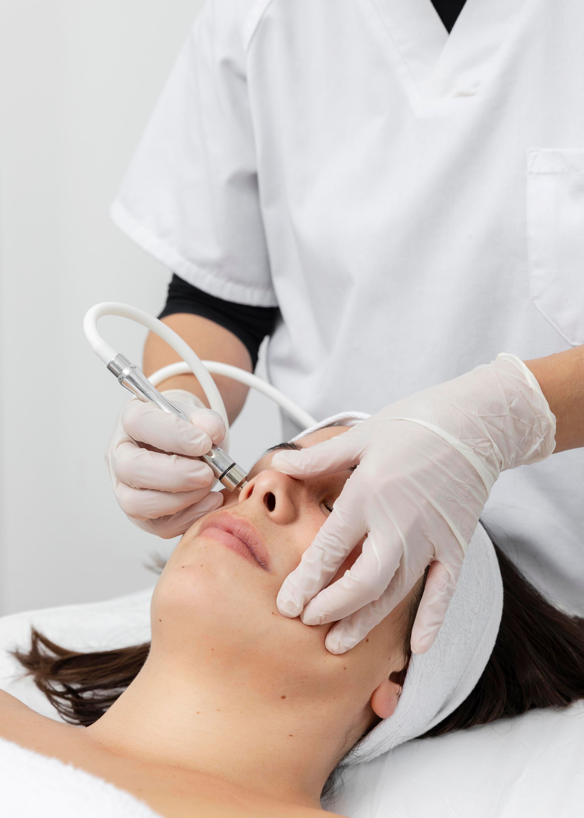 A woman is getting a facial treatment at a beauty salon.