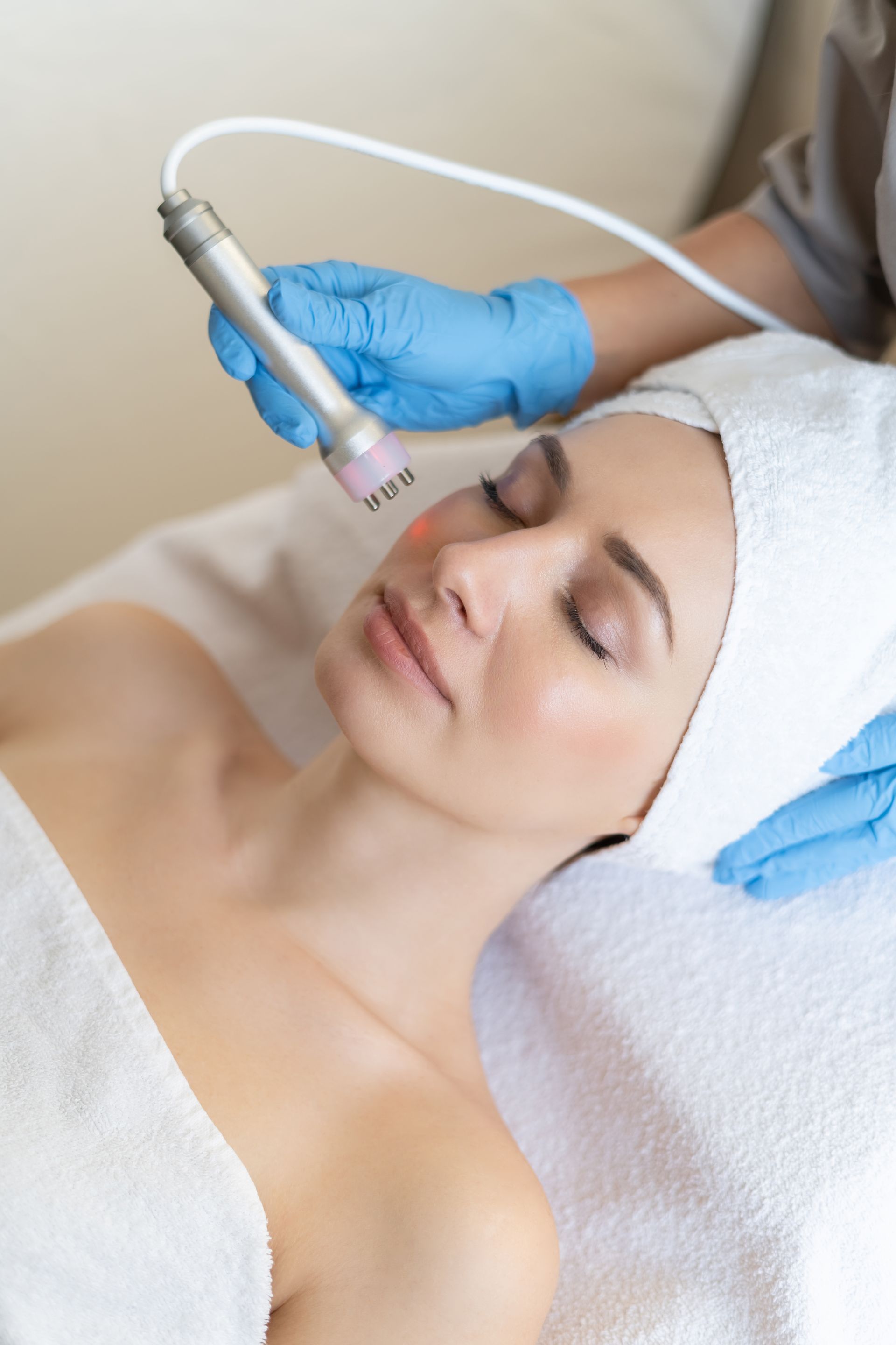 A woman is getting a facial treatment at a spa.