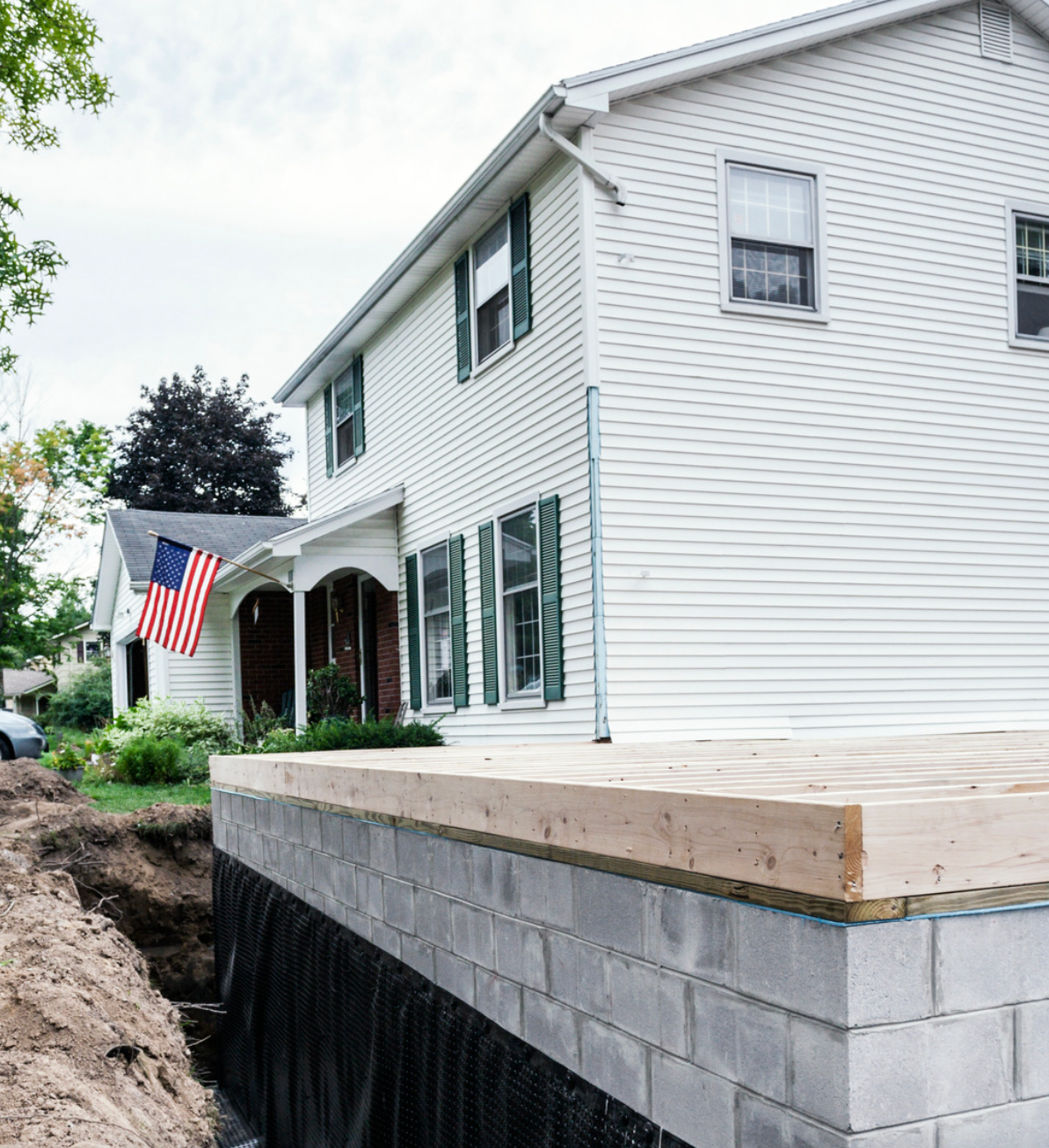 A white house with an american flag on the porch