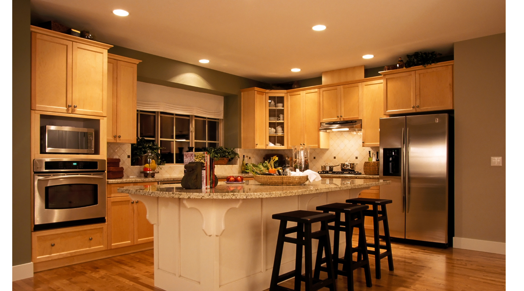 A kitchen with stainless steel appliances and wooden cabinets