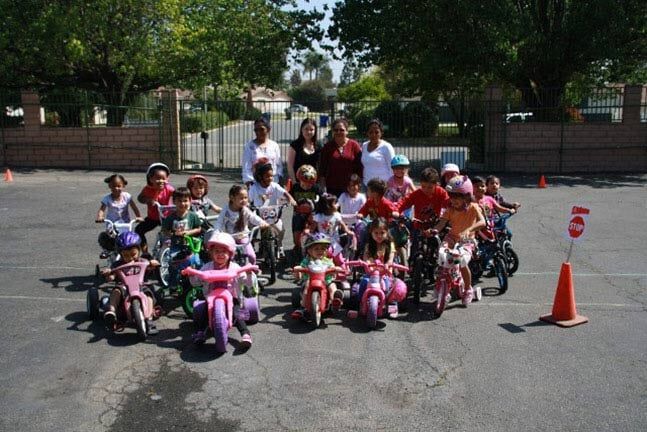 Group of Kids Playing Bikes at the Park — Riverside, CA — Cottonwood Montessori