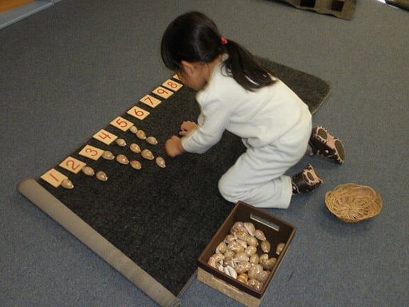 Little Girl Playing Shells — Riverside, CA — Cottonwood Montessori