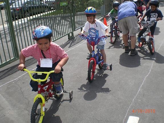 Children Having Bicycle Race — Riverside, CA — Cottonwood Montessori