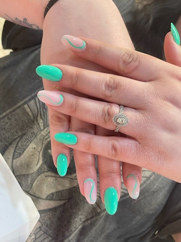 Hands display an almond-shaped manicure featuring alternating solid mint green nails and sheer nails with mint swirl art.