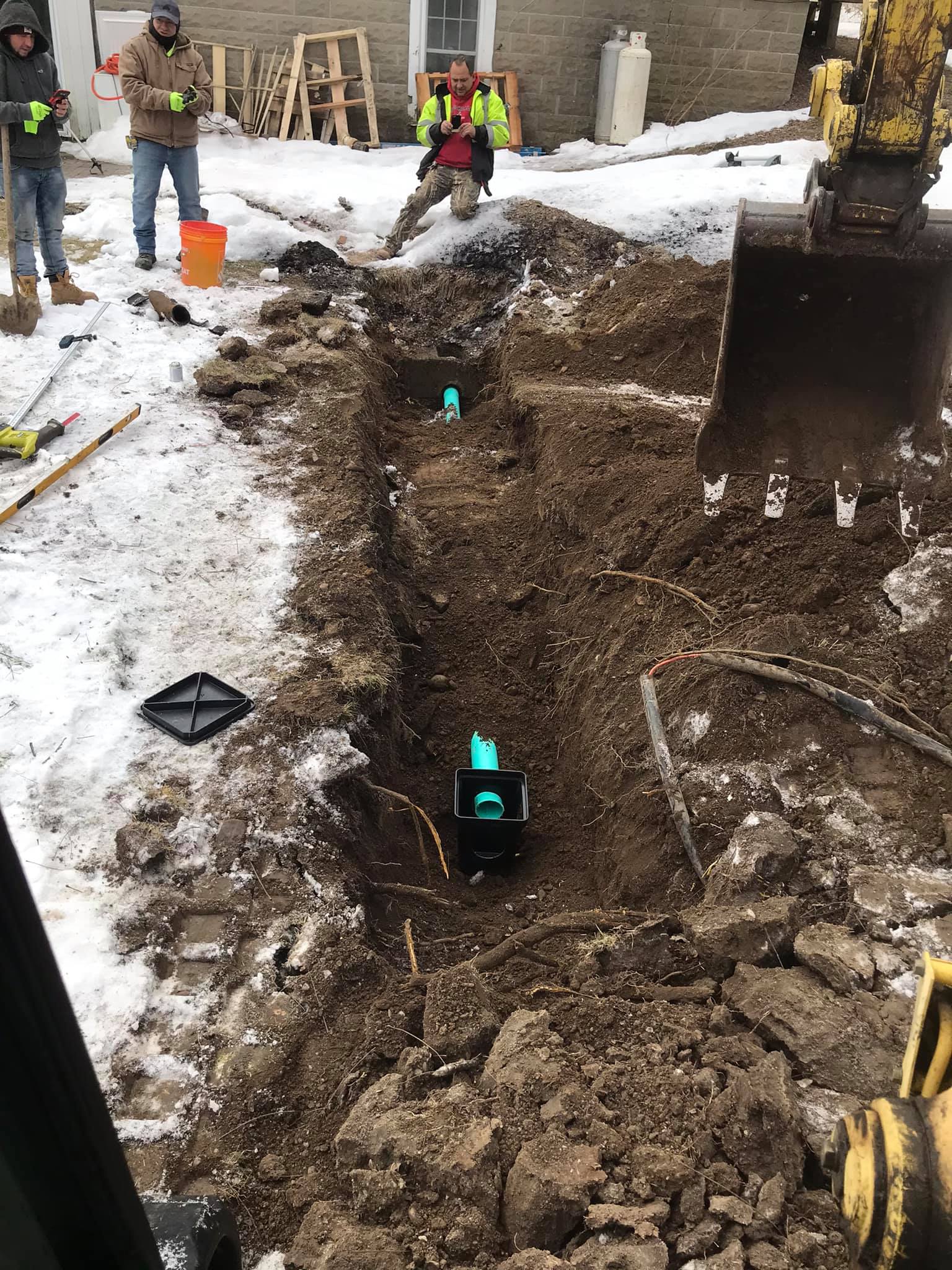 A group of construction workers are digging a hole in the ground.