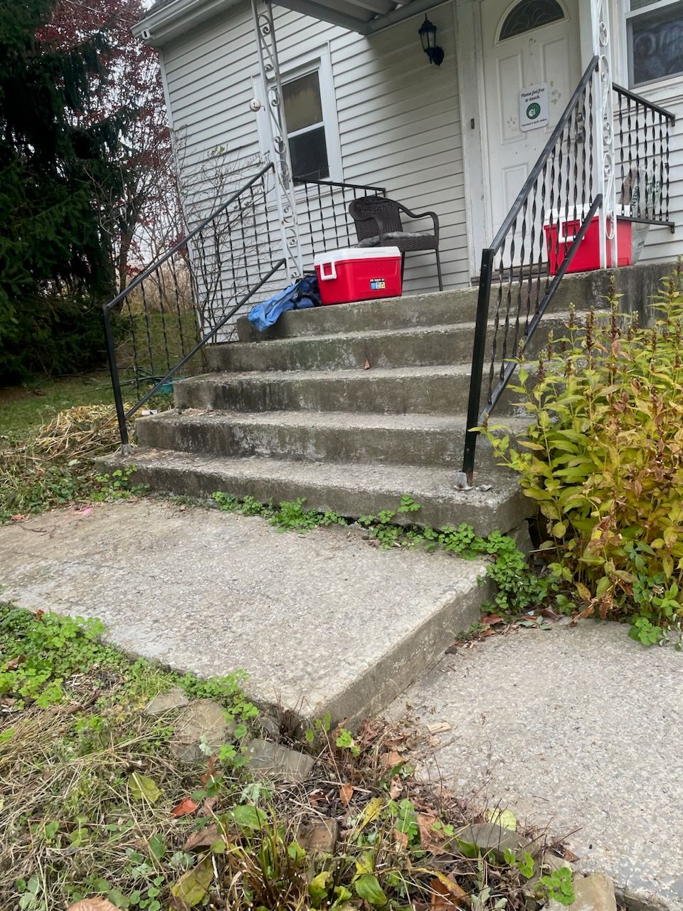 A red cooler sits on the porch of a house