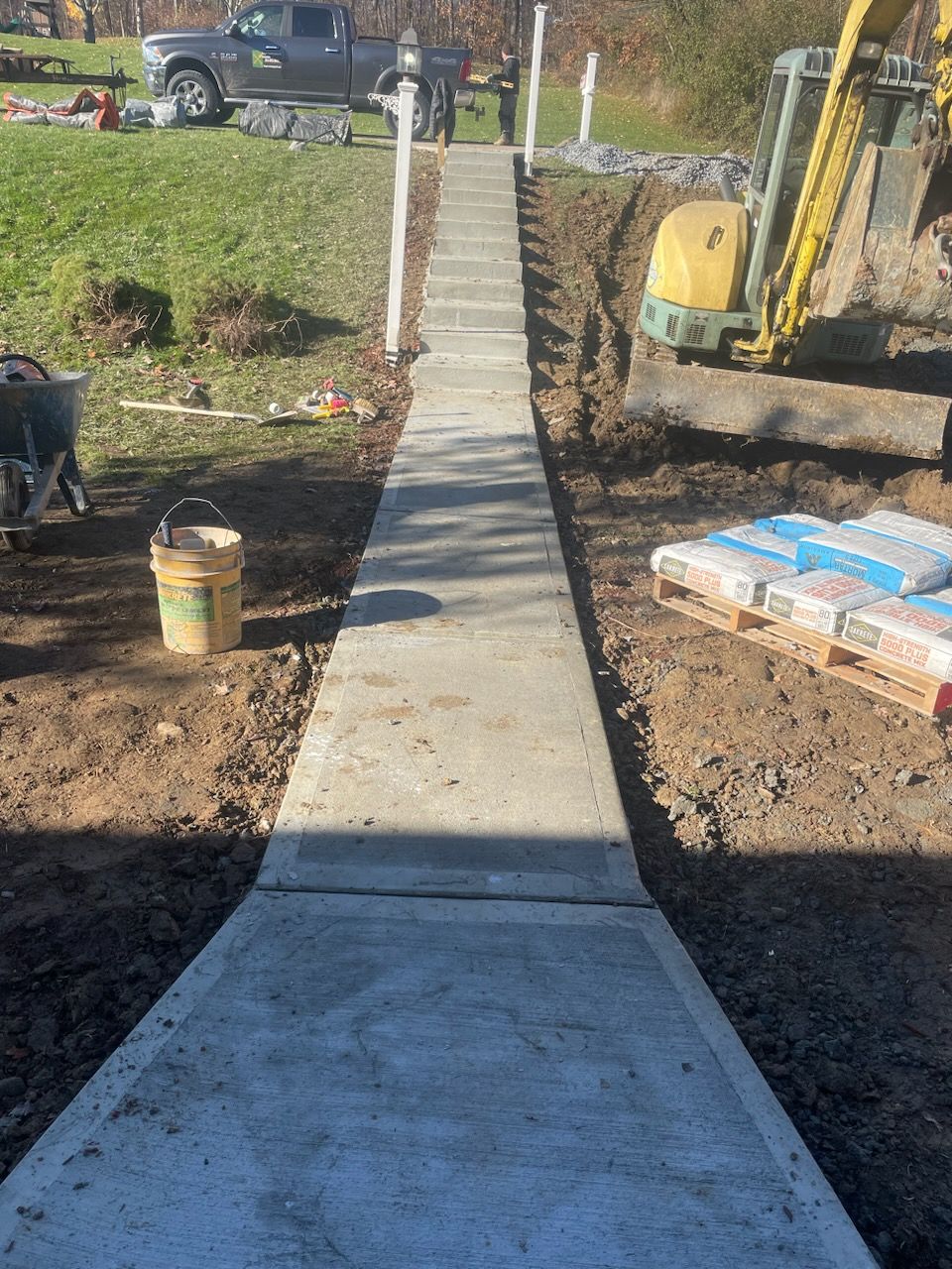 A concrete walkway is being built in a yard.
