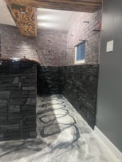 A room with a brick wall and a marble floor.