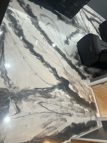 A black and white marble counter top in a kitchen.