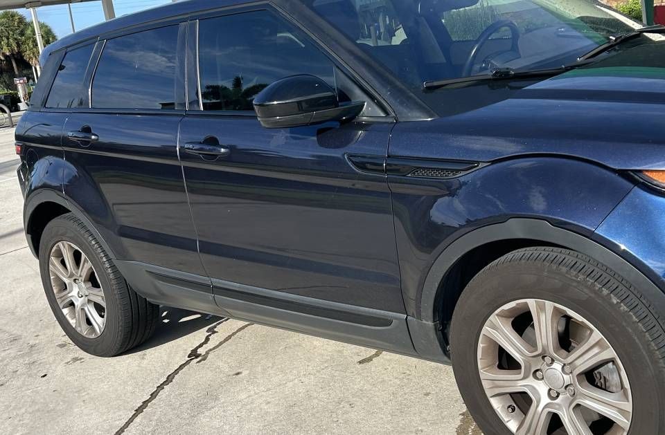 Dark blue SUV parked outdoors.
