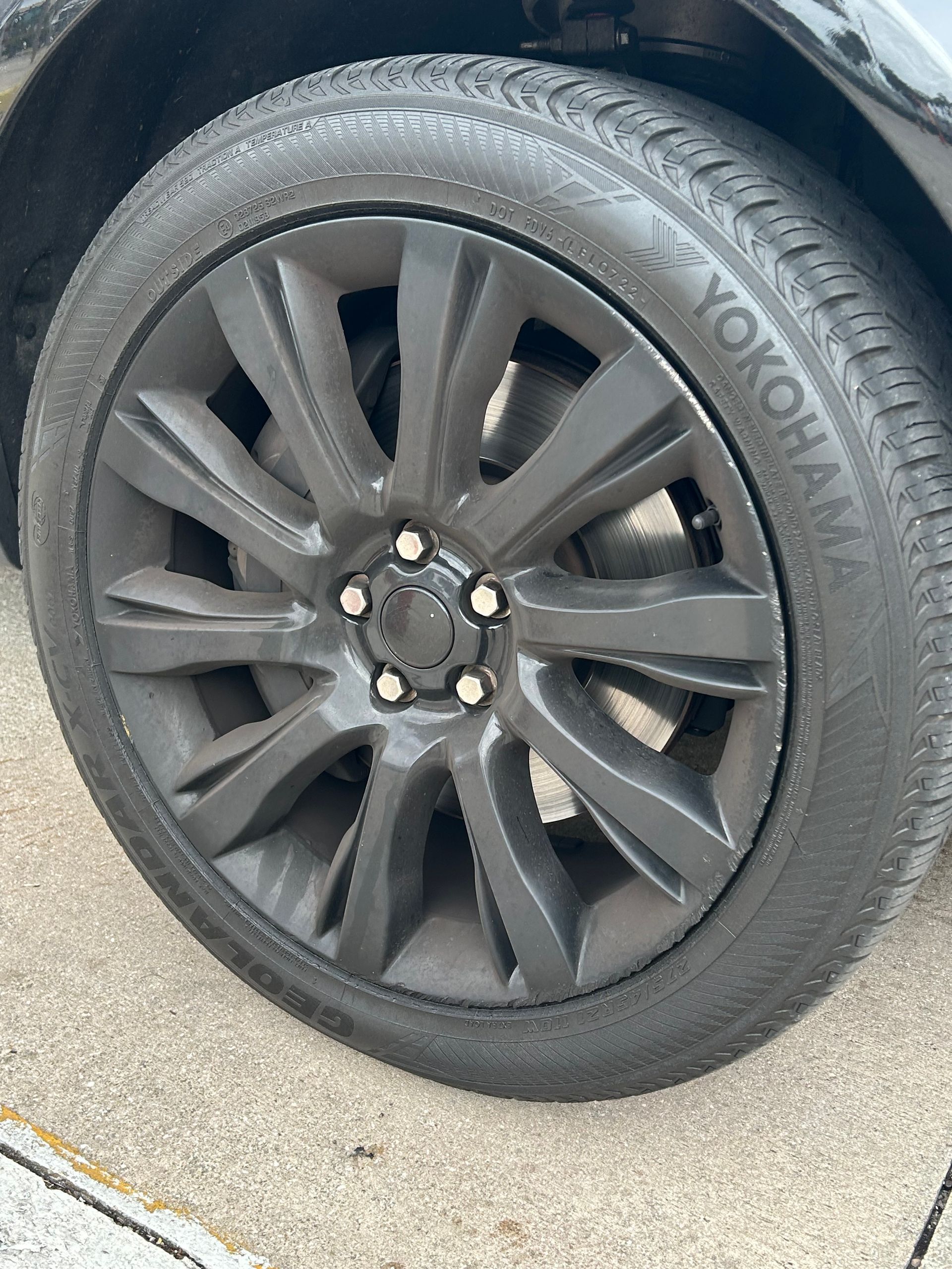 Black car tire with a gray rim. Yokohama tire branding is visible.