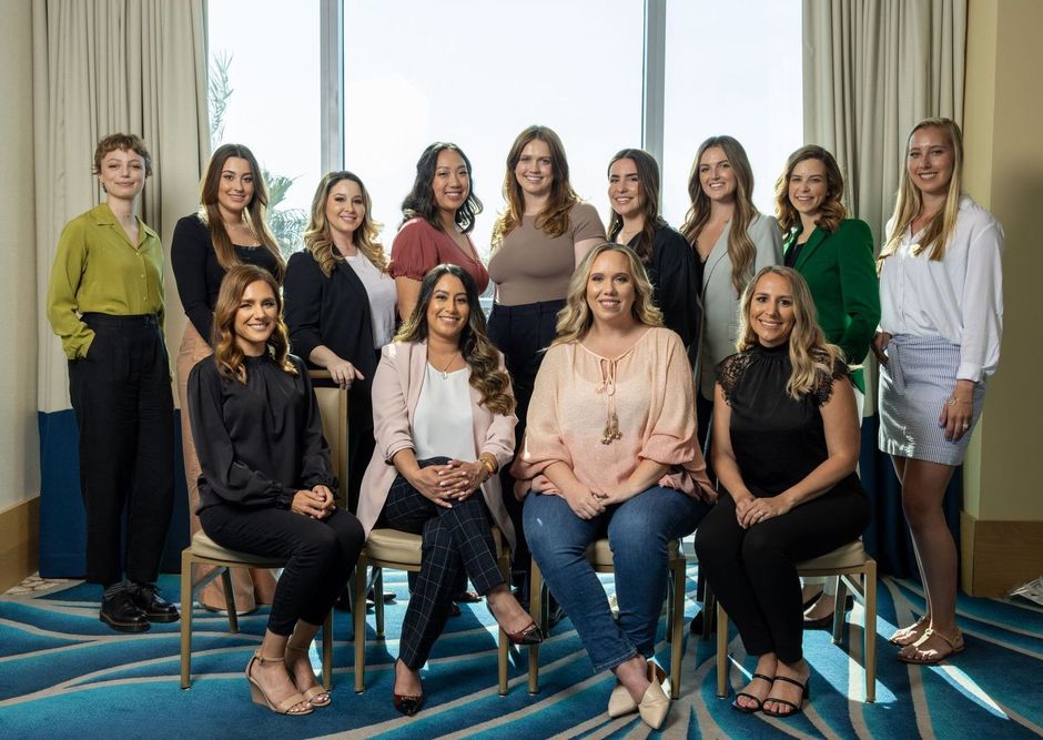 A group of women are posing for a picture in a room.