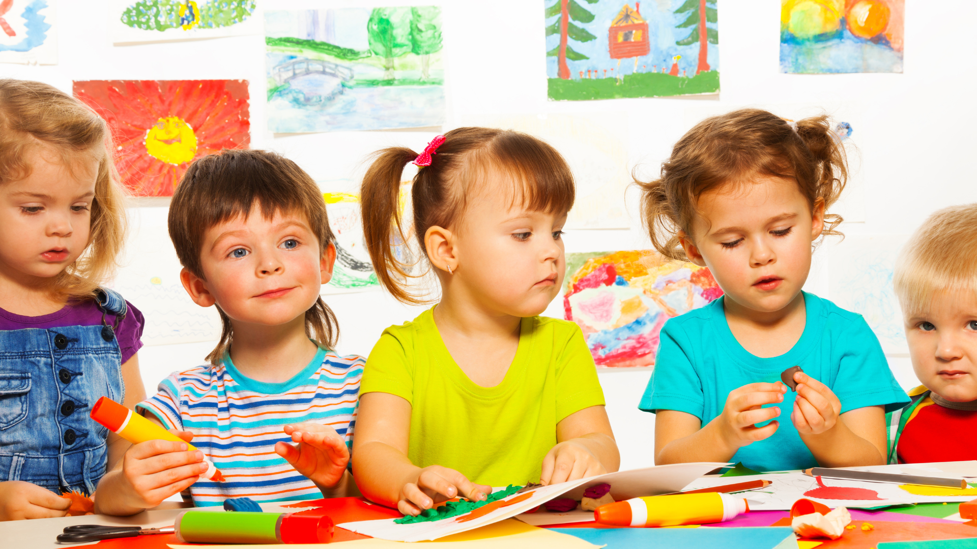Children at a craft table, working with paint and clay.