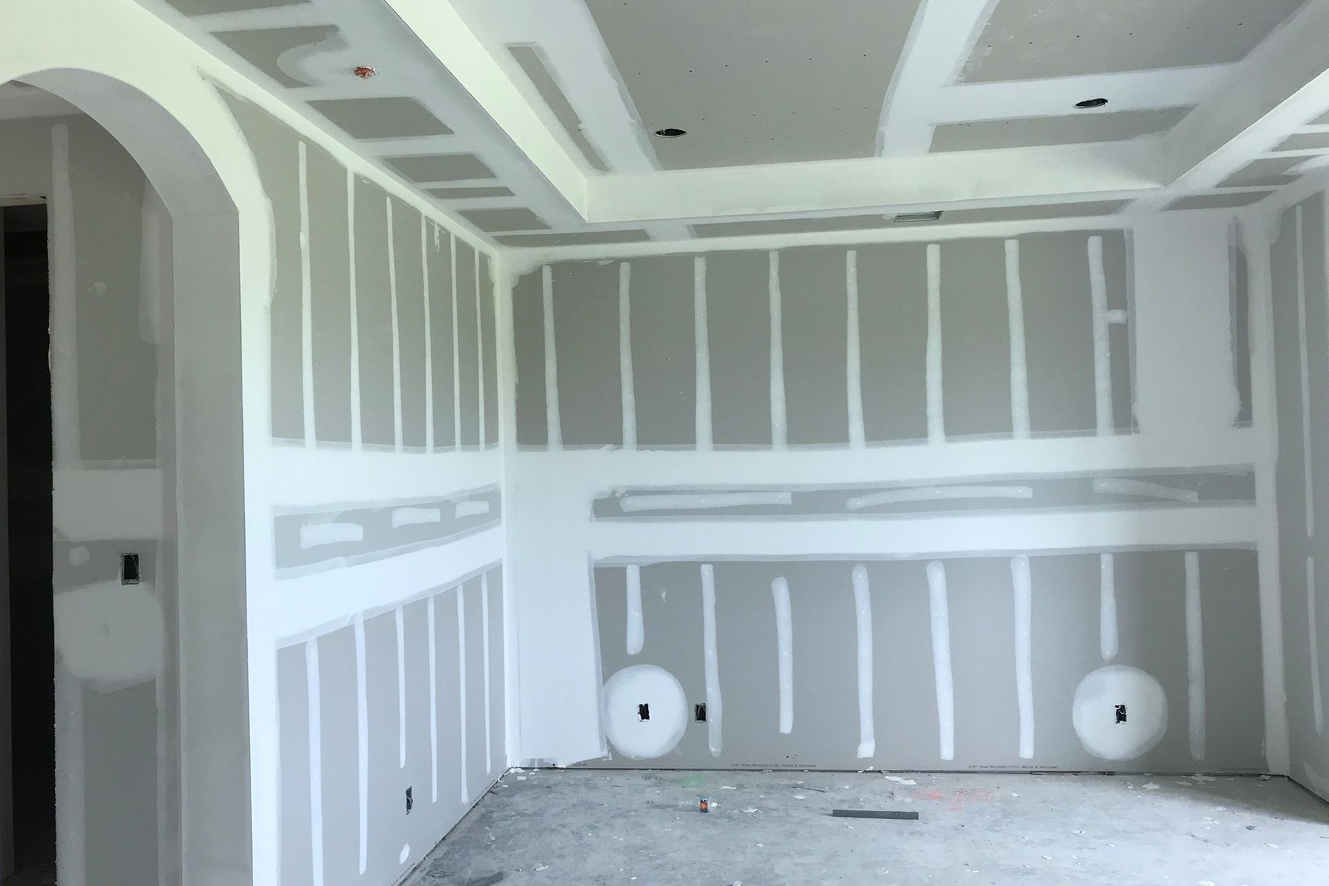 A room with a lot of drywall on the walls.