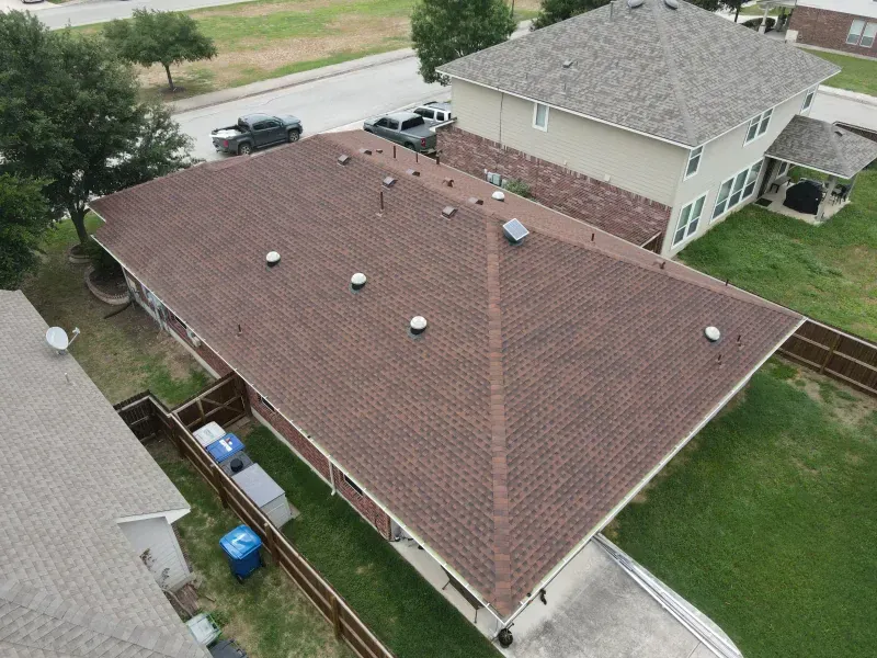 An aerial view of a house with a brown roof