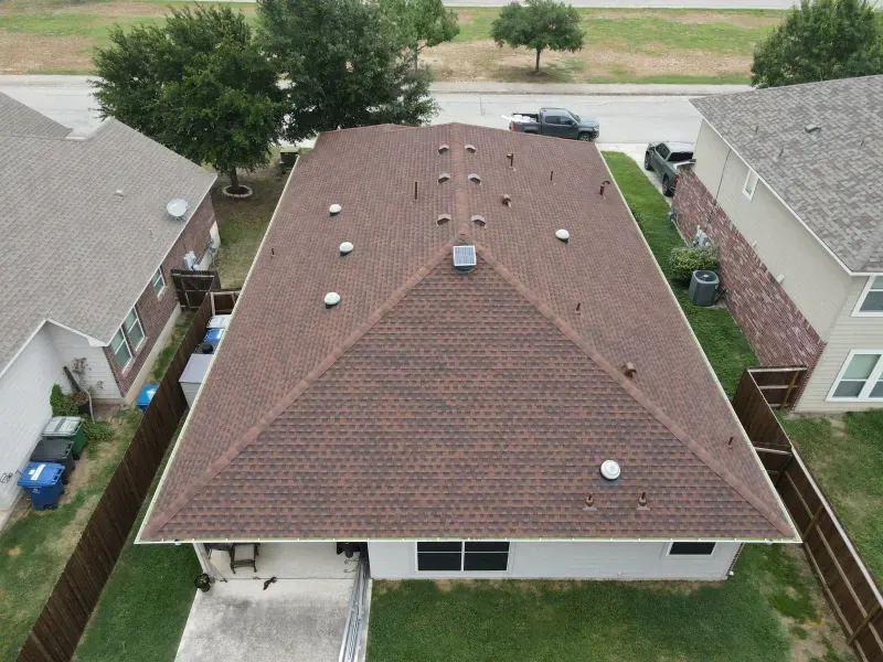 An aerial view of a house with a brown roof.