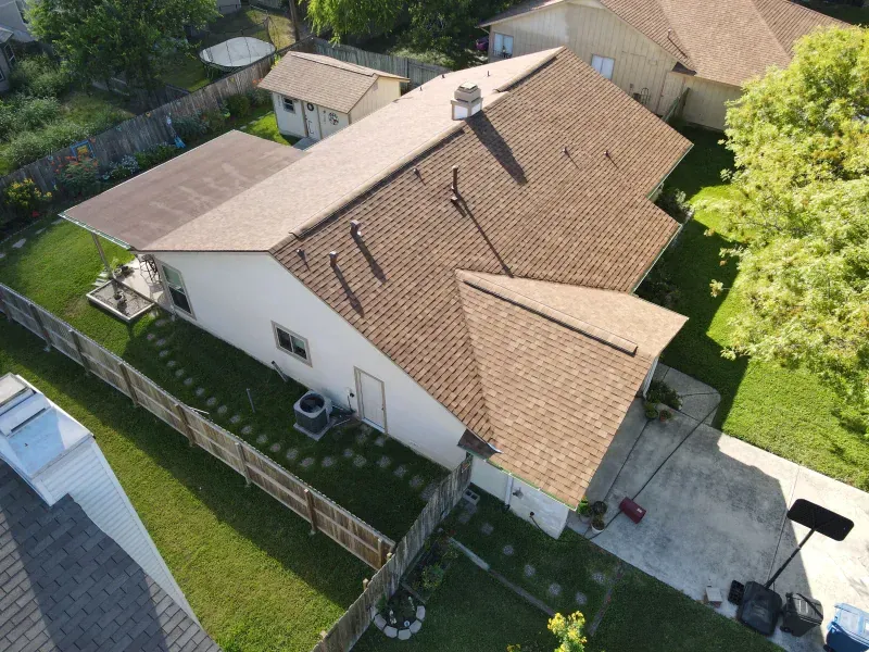 An aerial view of a house with a brown roof
