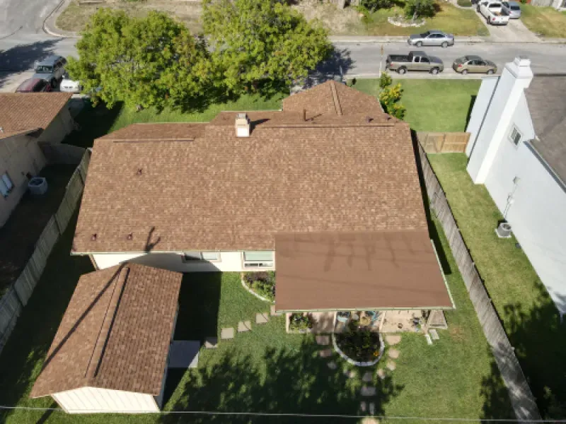 An aerial view of a house with a brown roof