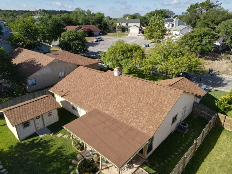 An aerial view of a house with a brown roof