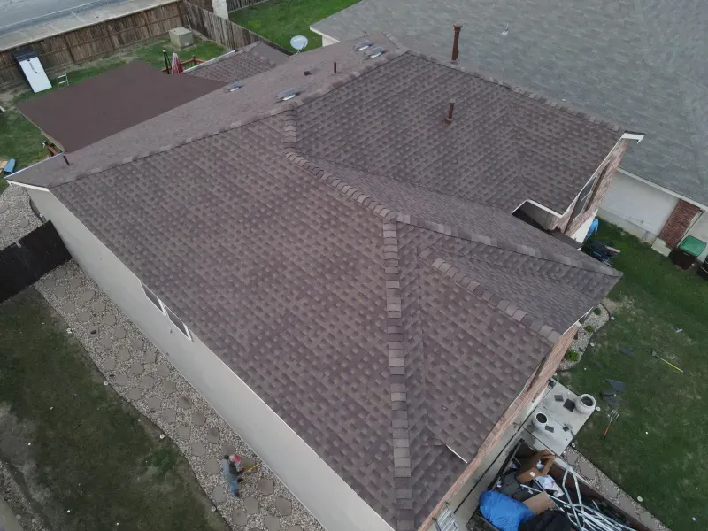 An aerial view of a house with a brown roof.