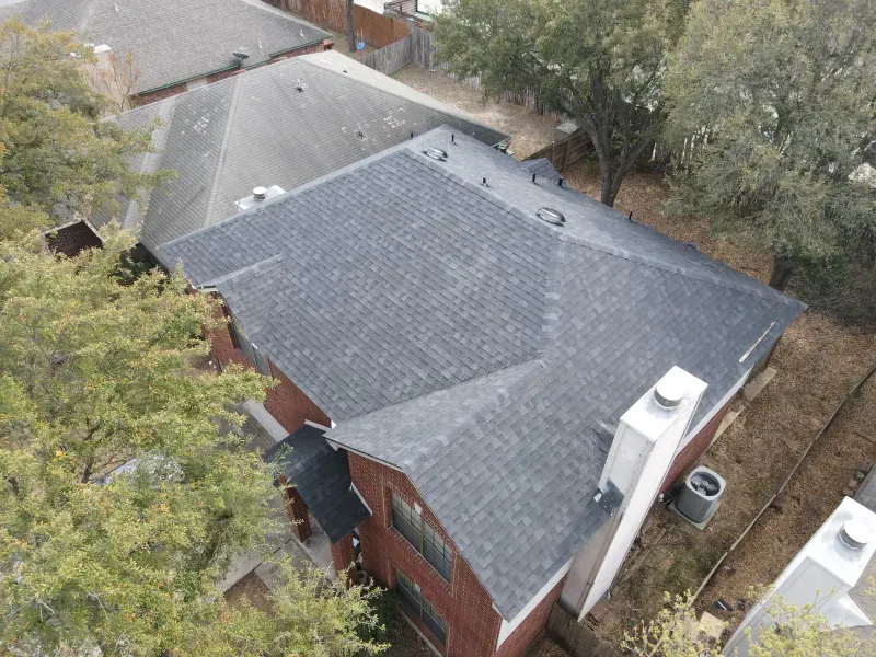An aerial view of a house with a roof that is covered in shingles.