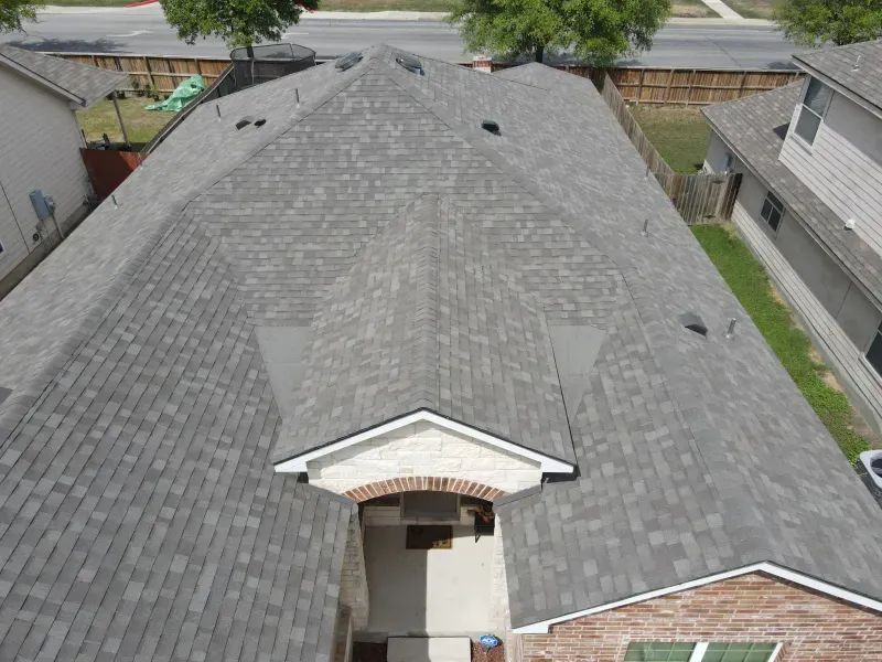 An aerial view of a house with a gray roof